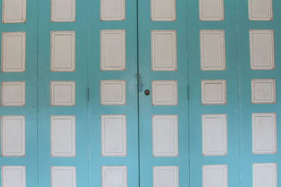 Blue folding wooden door with white frame, chino portuguese architecture style, thailand