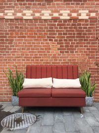 Sofa against brick wall