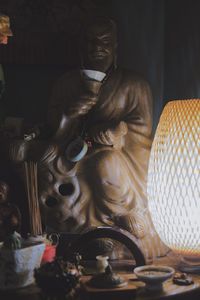 Close-up of buddha statue on table in building