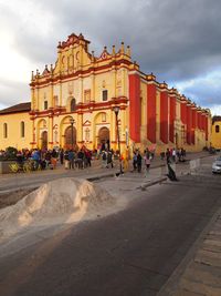 Tourists looking at cloudy sky