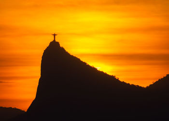 Silhouette of temple against sky during sunset