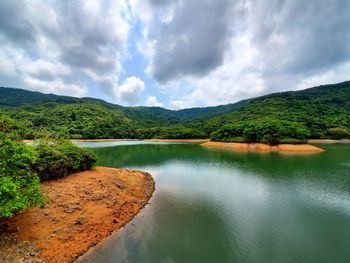 Scenic view of lake and mountains against sky