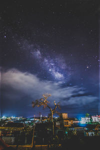 High angle view of illuminated city against star field