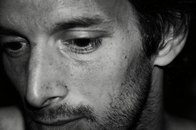 Close-up of thoughtful man in darkroom
