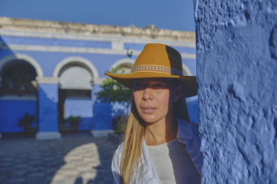 Portrait of young woman standing against sea