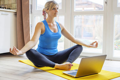 Young woman using laptop at home