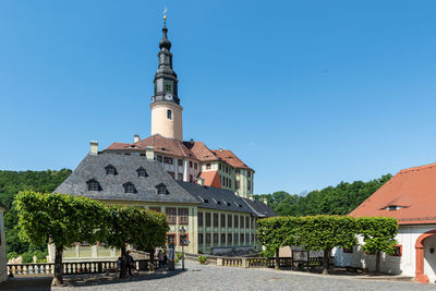 Low angle view of building against clear blue sky