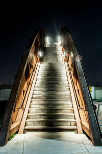 Low angle view of illuminated steps at night