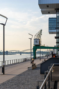 View of old freight crane on the banks of rhine river at port rheinauhafen
