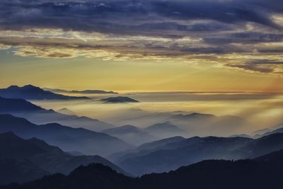 Scenic view of silhouette mountains against sky at sunset