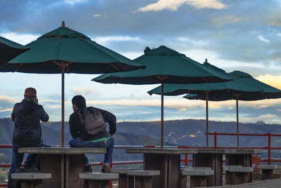 Two people with sunshades