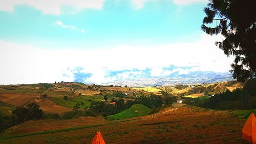 Scenic view of landscape against cloudy sky