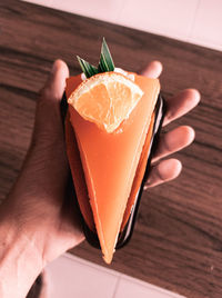 Close-up of hand holding ice cream