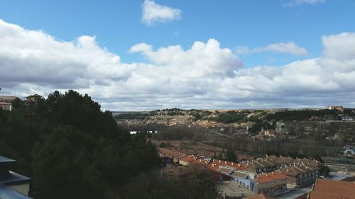 Cityscape against cloudy sky