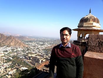 Portrait of man at jaigarh fort against cityscape