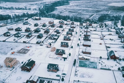 High angle view of snow covered buildings in city