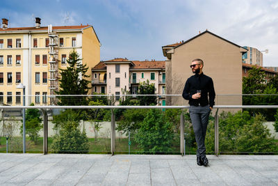 Full length of man standing by building