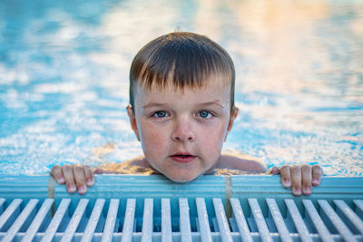 Portrait of boy swimming in pool
