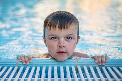 Portrait of boy swimming in pool