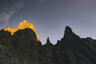 Low angle view of rocky mountains against sky