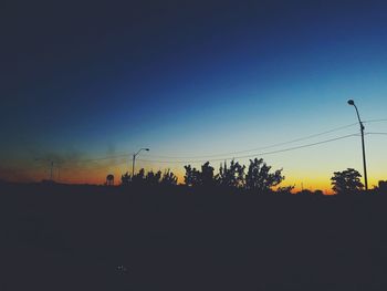 Scenic view of silhouette landscape against clear sky at sunset