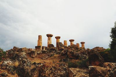 Low angle view of old ruins on hill against sky