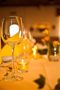 Close-up of wineglass on dining table during wedding ceremony