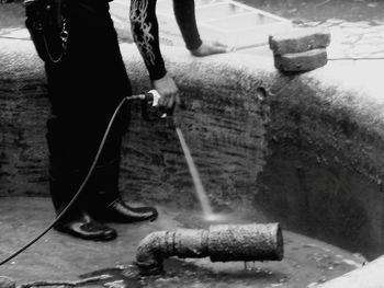 Low section of man working on water in city