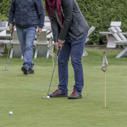 Low section of people playing golf