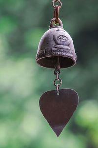 Close-up of heart shape hanging on metal