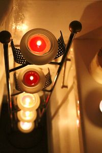 Close-up of illuminated tea light candles on table