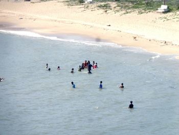 High angle view of people enjoying at beach