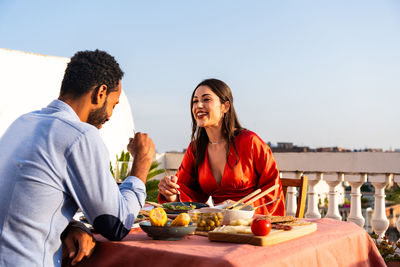 Portrait of smiling friends sitting at restaurant