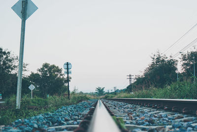 Surface level of railroad tracks against clear sky