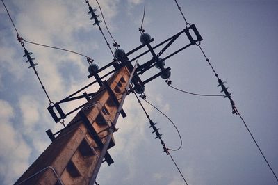 Low angle view of power lines against sky