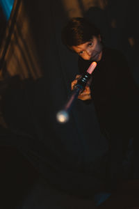 Boy playing with sword at theater