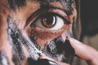 Close-up portrait of woman with dirty face