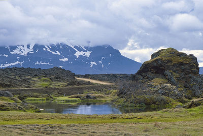 Scenic view of lake and mountains against sky