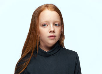 Portrait of teenage girl against white background