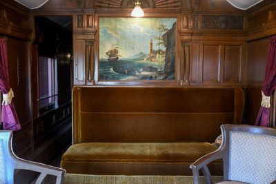 Empty chairs and table in building