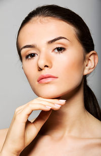 Portrait of a beautiful young woman over white background