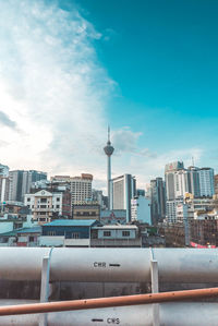 Modern buildings in city against blue sky