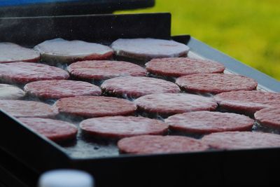 Close-up of hamburgers on barbecue grill