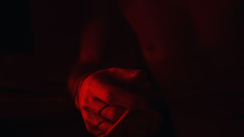 Close-up of hands against black background