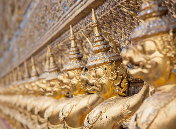 Close-up of buddha statue against temple building