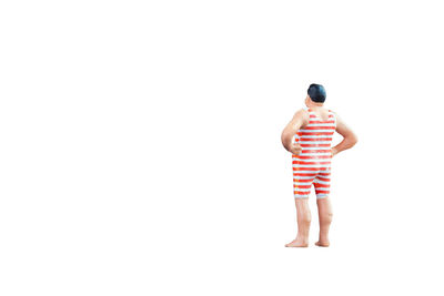 Rear view of shirtless man standing against white background