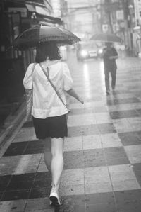 Woman standing on sidewalk
