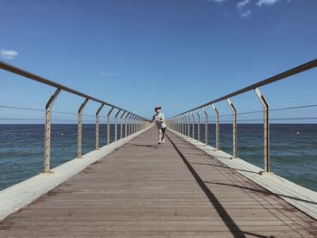 Man walking on pier