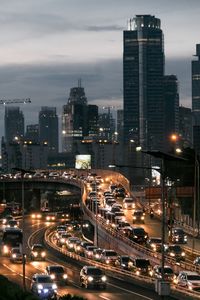 Vehicles on highway in city at night