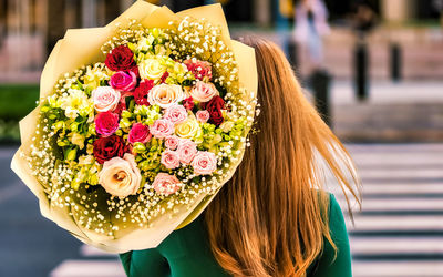 Rear view of woman with bouquet